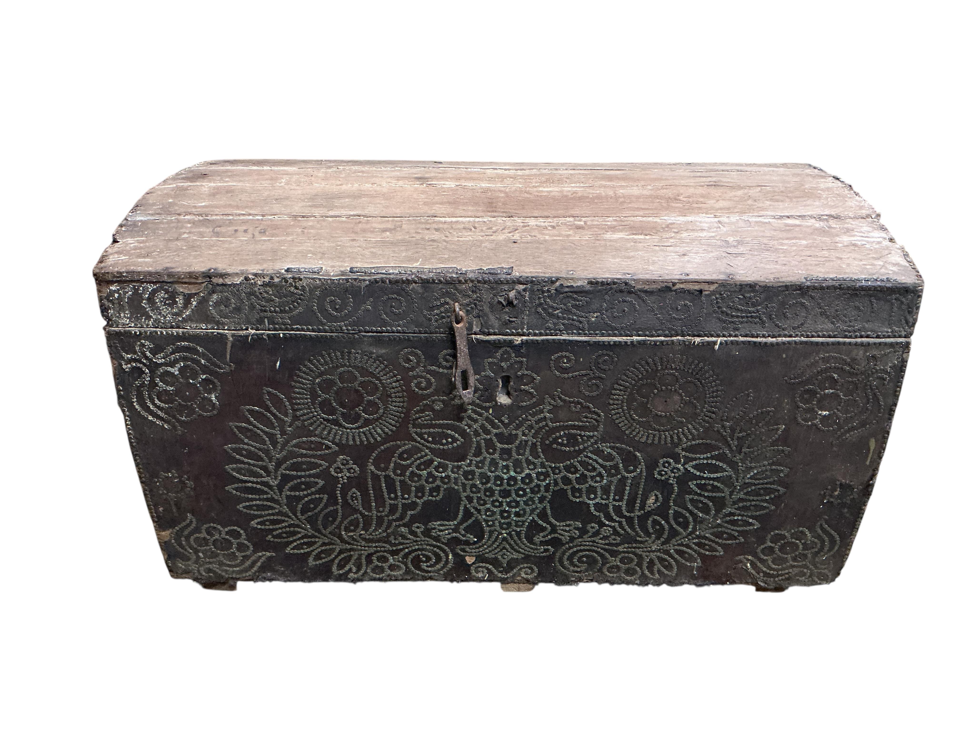 An 18th century oak domed trunk the front with the remnants of studded leather work, width 118cm, depth 53cm, height 65cm
